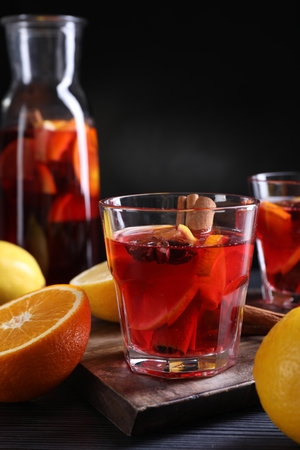 Aromatic punch drink and ingredients on black tableの写真素材