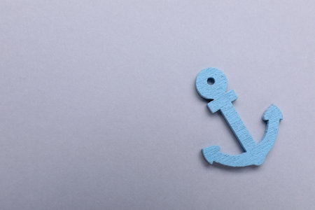Anchor figure on light gray background, top view. Space for text