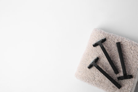 Razors and towel on white background, top view. Space for textの写真素材