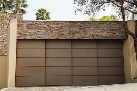Brown garage with closed sectional door. Exterior designの写真素材