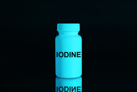 Plastic container of medical iodine on black background, color tone effectの写真素材