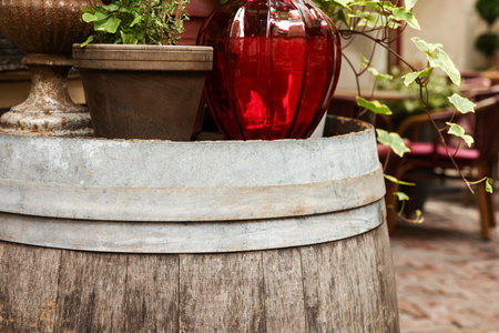 Traditional wooden barrel and different pots with plants outdoorsの写真素材
