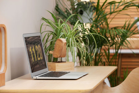 Cozy workspace with laptop on wooden desk at home