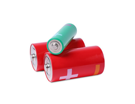 New AA and C size batteries isolated on white