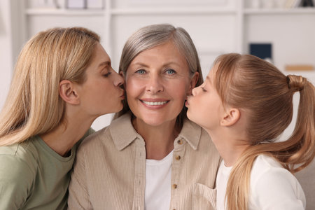 Three generations. Happy grandmother, her daughter and granddaughter at home