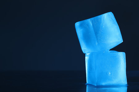 Crystal clear ice cubes on dark background, space for text. Color tone effectの写真素材