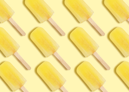 Pattern with ice cream on pastel yellow backgroundの写真素材