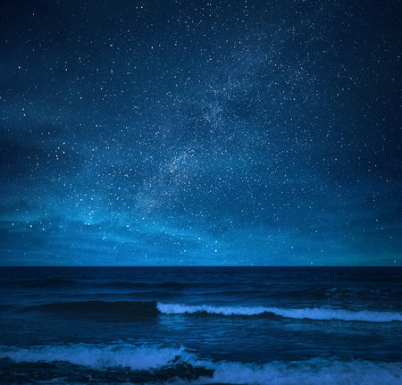 Amazing starry sky over sea at nightの写真素材