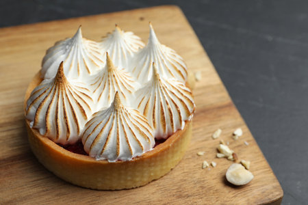 Tartlet with meringue on black table, closeup and space for text. Delicious dessertの写真素材