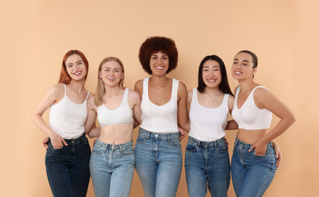 Group of beautiful young women on beige backgroundの写真素材