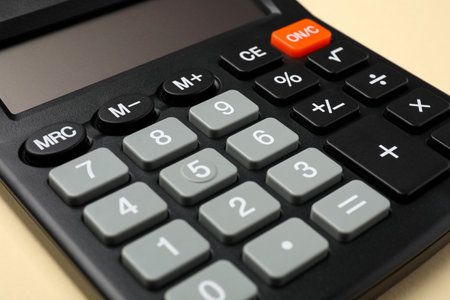 Calculator on beige background, closeup. Office equipmentの写真素材