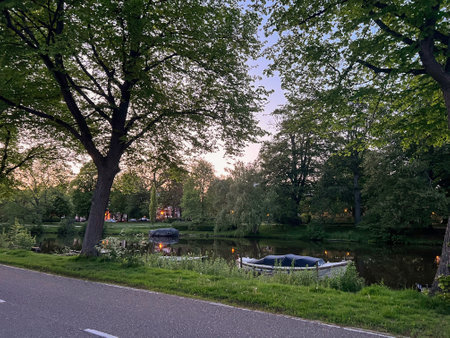 Road near canal with moored boats outdoorsの写真素材