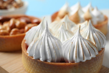 Tartlet with meringue on wooden board, closeup. Delicious dessertの写真素材