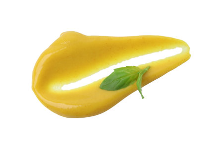 Smear of tasty curry sauce and basil leaf isolated on whiteの写真素材