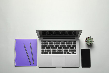 Flat lay composition with laptop and smartphone on light background. Space for textの写真素材