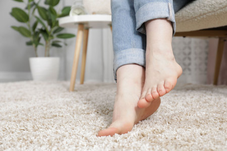 Woman sitting in armchair at home, closeupの写真素材