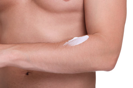 Man with sun protection cream on his arm against white background, closeupの写真素材