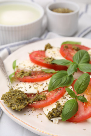 Plate of delicious Caprese salad with pesto sauce on table, closeupの写真素材