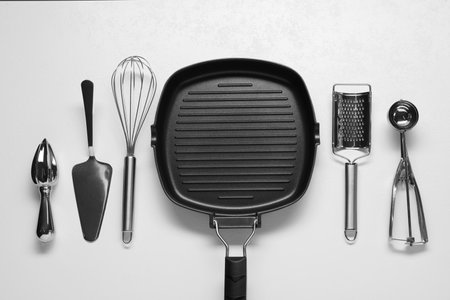 Set of different kitchen utensils on white table, flat layの写真素材