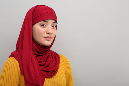 Portrait of Muslim woman in hijab on light gray background, space for textの写真素材