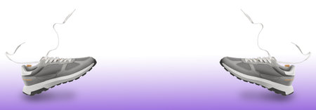 Pair of stylish sneakers in air on color gradient background. Banner design with space for textの写真素材