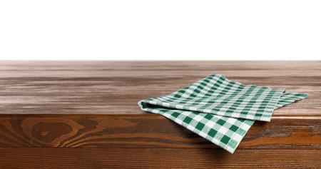 Checkered tablecloth on wooden table against white backgroundの写真素材