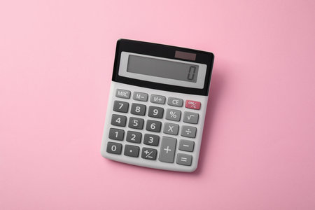 Calculator on pink background, top view. Office equipmentの写真素材