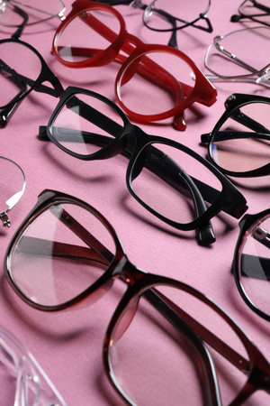 Many different stylish glasses on pink background, closeupの写真素材