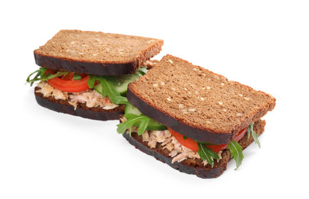 Delicious sandwiches with tuna and vegetables on white backgroundの写真素材