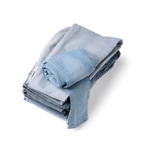 Stack of different folded jeans isolated on whiteの写真素材