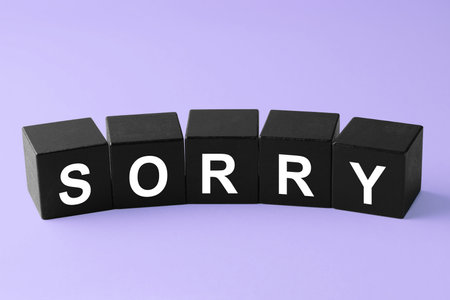 Apology. Word Sorry made of black cubes on violet backgroundの写真素材