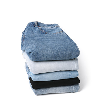 Stack of different folded jeans isolated on whiteの写真素材
