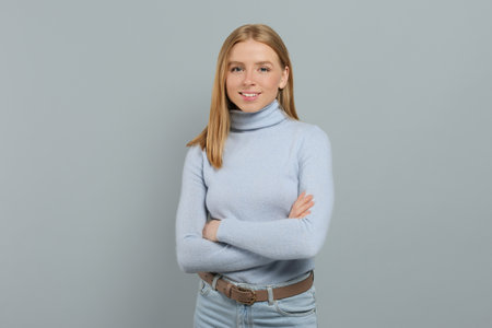 Portrait of beautiful young woman on gray backgroundの写真素材