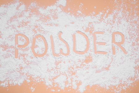 Word Powder made of baby cosmetic product on pale coral background, top viewの写真素材