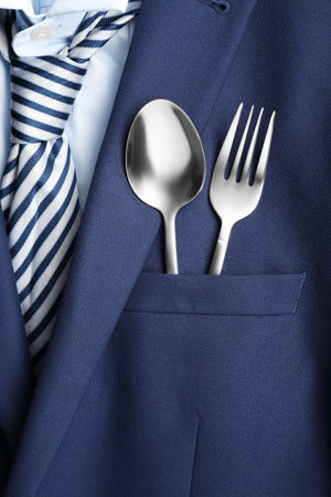 Cutlery in breast pocket of men`s jacket as background, closeup. Business lunch conceptの写真素材