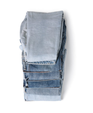 Stack of different folded jeans isolated on whiteの写真素材