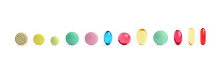 Set of different color pills in row isolated on white