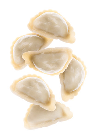 Tasty dumplings (varenyky) falling against white backgroundの写真素材