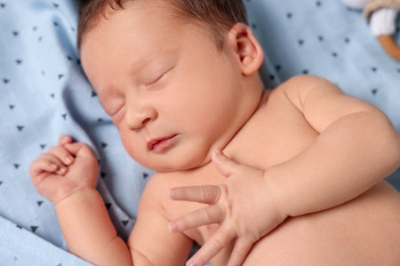 Cute newborn baby sleeping on bed, closeupの写真素材