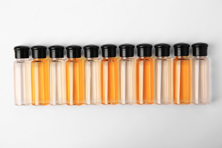 Bottles of cosmetic products on white background, flat layの写真素材