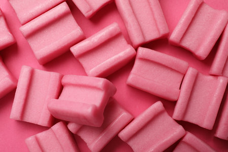 Tasty chewing gums on pink background, flat layの写真素材
