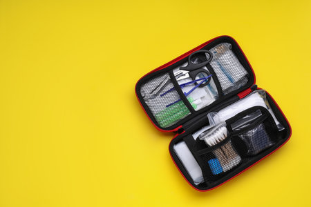 First aid kit on yellow background, top view and space for textの写真素材