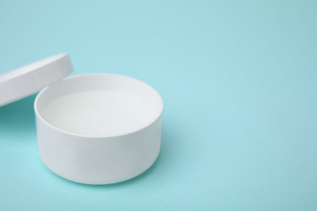 Jar of petroleum jelly on light blue background, space for textの写真素材