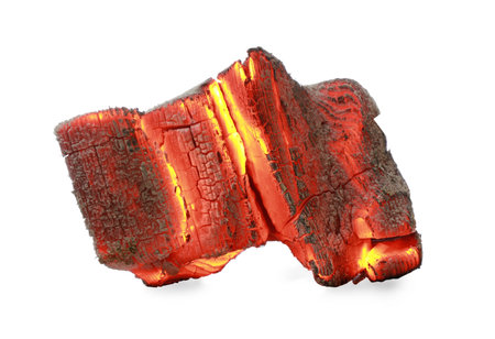 Piece of smoldering coal isolated on whiteの写真素材