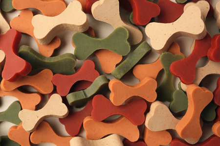 Many bone shaped vitamins for pets as background, top viewの写真素材