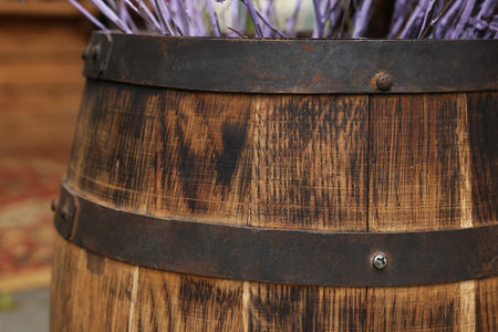 Traditional wooden barrel and decorative branches outdoors, closeupの写真素材