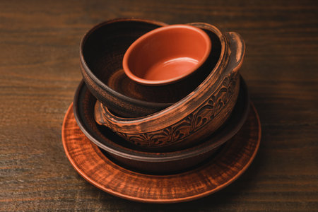 Set of clay dishes on wooden table. Cooking utensilsの写真素材