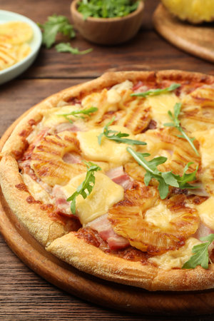 Delicious pineapple pizza with arugula on wooden table, closeupの写真素材