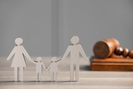Family law. Figure of parents with children and gavel on wooden table, space for textの写真素材
