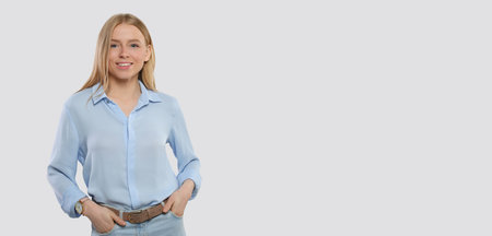 Portrait of beautiful young woman on light background. Banner design with space for textの写真素材